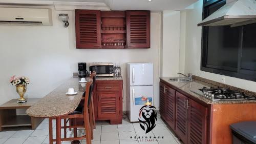 a kitchen with a counter top and a refrigerator at Residence Blue Sky in Douala