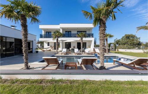 a villa with a swimming pool and palm trees at Villa Quercus in Briševo