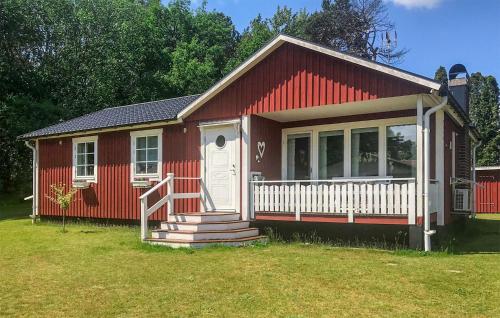 a red house with a white door and a porch at 3 Bedroom Lovely Home In Sölvesborg in Sölvesborg