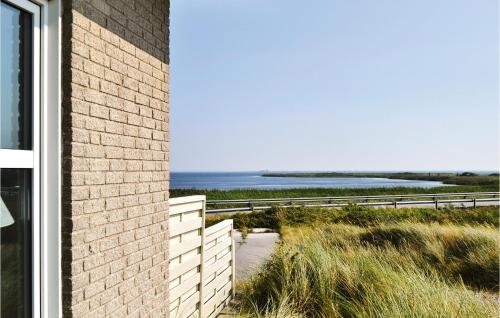 a brick house with a view of the ocean at Three-Bedroom Holiday Home In Hvide Sande in Havrvig