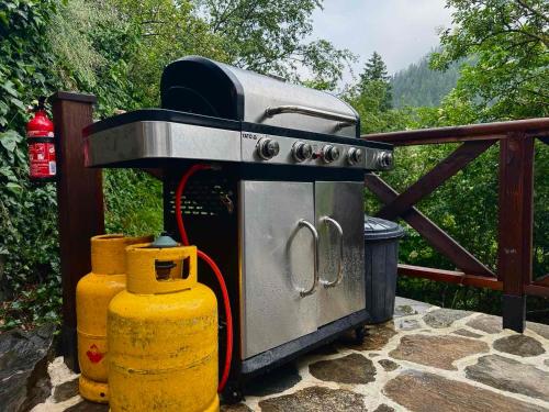 a grill sitting on a patio next to a fence at Spa Villa Mezinska Jacuzzi Sauna in Shiroka Lŭka