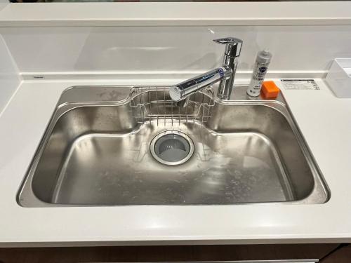 a sink in a kitchen with water in it at Casa Stella 9 by Liaison in Osaka