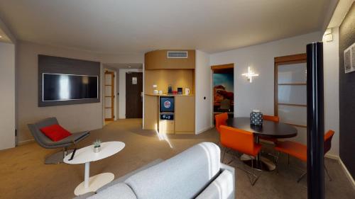 a living room with a couch and a table at Novotel Lyon Gerland Musée des Confluences in Lyon