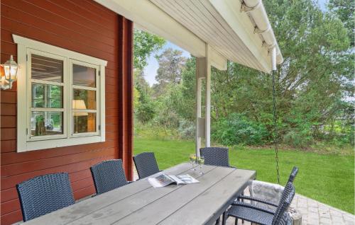 a wooden table and chairs on a patio at Beautiful Home In Kalundborg With Sauna in Kalundborg