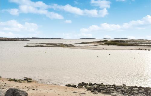 a beach with a bunch of rocks in the sand at Amazing Apartment In Åsa With Kitchen in Åsa
