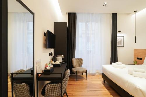 a hotel room with a bed and a desk and a bedroom at No Man's Land Guesthouse in Rome