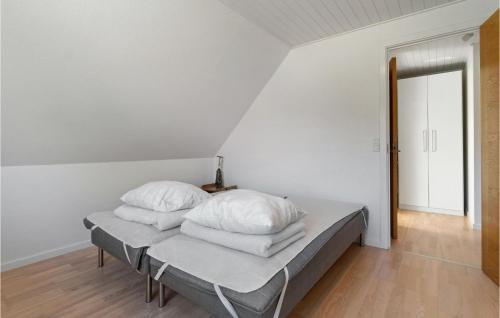 a bedroom with a bed with white pillows on it at 3 Bedroom Stunning Apartment In Hasle in Hasle