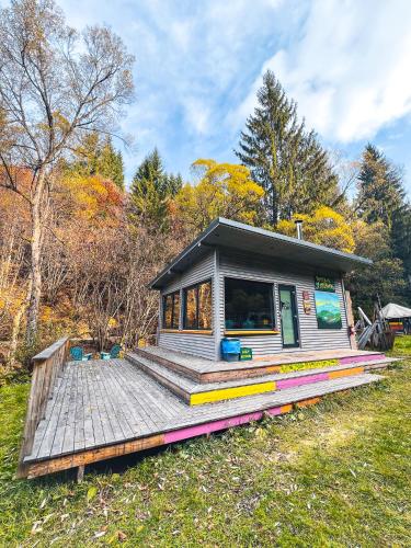 a small tiny house on a wooden deck at Fain in Lunca Bradului