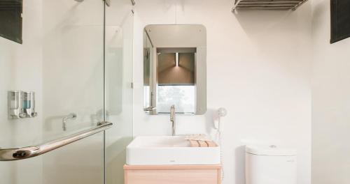 a bathroom with a sink and a mirror at Bobocabin Pacet, Mojokerto in Claket