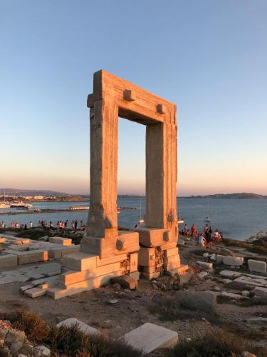 a monument on the beach with a group of people at Villa Margarita 3 Bedroom Villa with Private Pool and Sea View in Naxos Chora