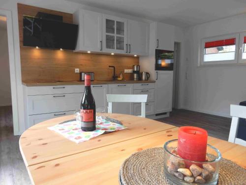 a bottle of wine sitting on a table in a kitchen at Haus am Nordstrand 2 in Prerow