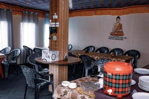 a room with a lot of chairs and a table and a room with a lot at Wanderlust Cottage Pangong Lake, Lukung, in Lukung