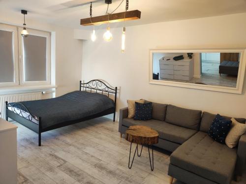 a living room with a couch and a bed at Przy Moście in Rzeszów