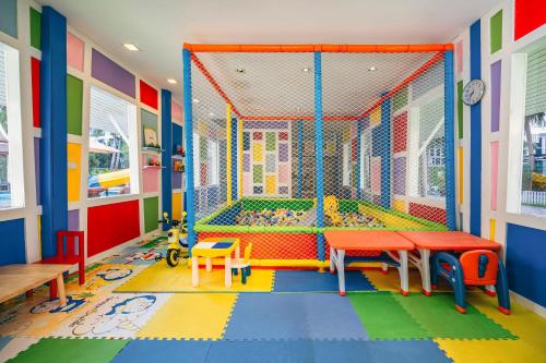 a brightly colored play room with a play structure at Heeton Concept Hotel Pattaya by Compass Hospitality in Pattaya