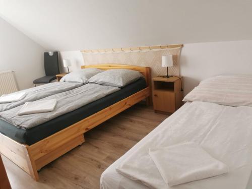a bedroom with two beds and two night stands at Kiss Vendégház in Balatonlelle
