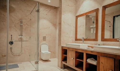 a bathroom with a shower and a toilet and a sink at Pushkara Resort and Spa, Pushkar in Pushkar