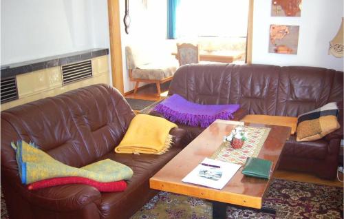 a living room with a couch and a coffee table at Holiday Home Am Einsberg Q in Tellerhäuser