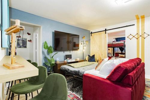 a bedroom with a bed and a red couch at Star Motel Unit 5- New Downtown Haven Boutique Las Vegas Oasis Home in Las Vegas