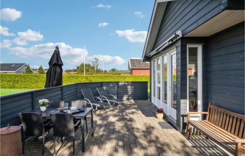 a patio with a table and chairs and an umbrella at 3 Bedroom Nice Home In Otterup in Otterup