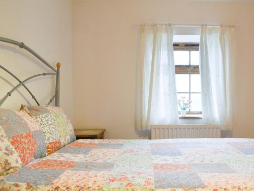 a bedroom with a bed and a window at Meadow Lodge-E4105 in Aspatria