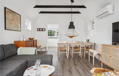 a living room with a couch and a table at Amazing Home In Otterup in Otterup