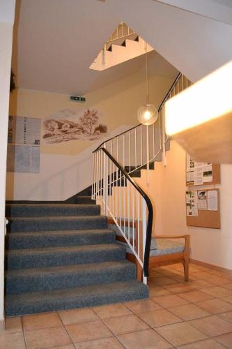 a staircase in a building with a stair case at Apartmán Almberg - Mitterdorf - Mitterfirmiansrout in Philippsreut