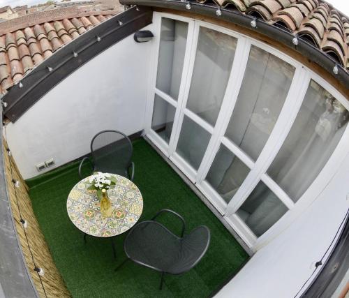 an overhead view of a table and chairs on a balcony at Casa Margot in Asti