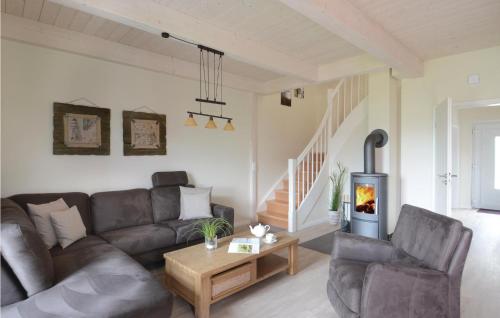 a living room with a couch and a table at Gorgeous Home In Dagebüll With Sauna in Dagebüll