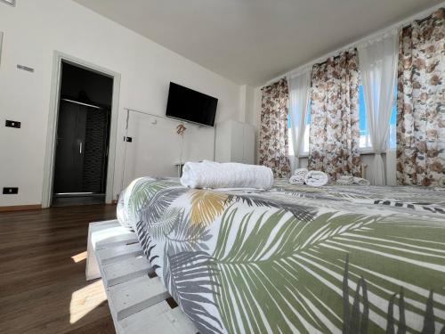 a bedroom with a large bed and a television at Villa COME A CASA TUA in Bari