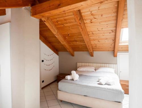 a bedroom with a bed with two towels on it at Casa Margot in Asti