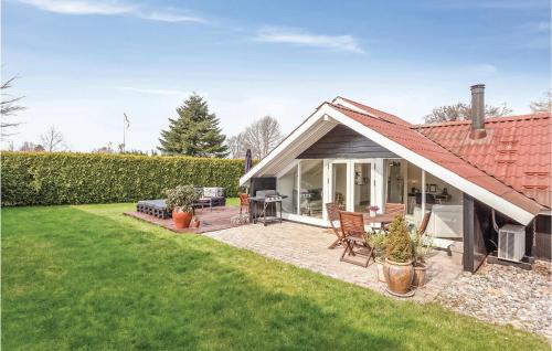 a house with a patio and a lawn at Beautiful Home In Karrebæksminde in Karrebæksminde