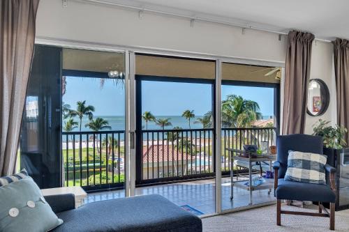 a living room with a view of the ocean at Gulf-View Condo with Resort-Style Amenities condo in Marco Island