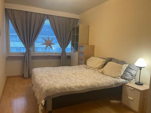 a bedroom with a large bed and a window at MP Kallio Apartment Helsinki in Helsinki
