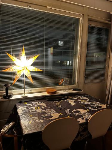 a dining room table with a star hanging from a window at MP Kallio Apartment Helsinki in Helsinki