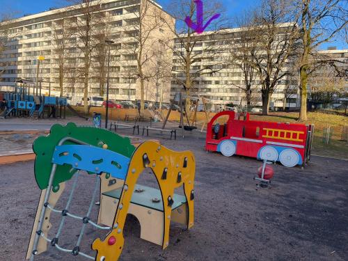 a playground with a toy train in a park at MP Kallio Apartment Helsinki in Helsinki