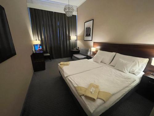 Postel nebo postele na pokoji v ubytování Hotel Zlatý Anděl