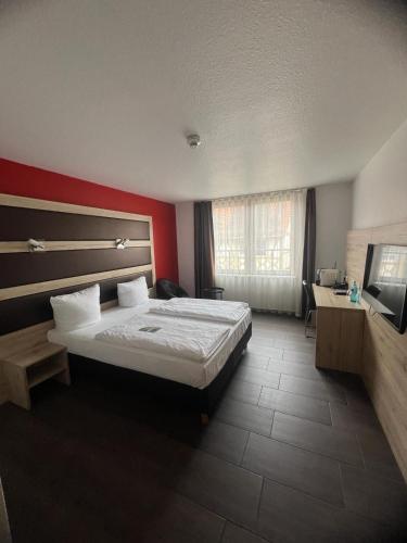 Ένα ή περισσότερα κρεβάτια σε δωμάτιο στο ACHAT Hotel Heppenheim