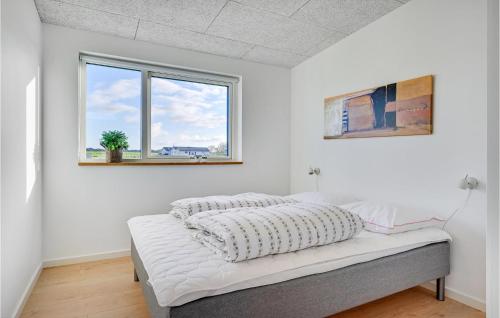 a bed in a room with white walls and windows at Lovely Home In Spøttrup With Wifi in Spottrup