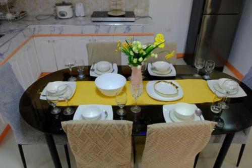 a dining room table with a yellow table cloth at RB Modern Condos in Zamboanga