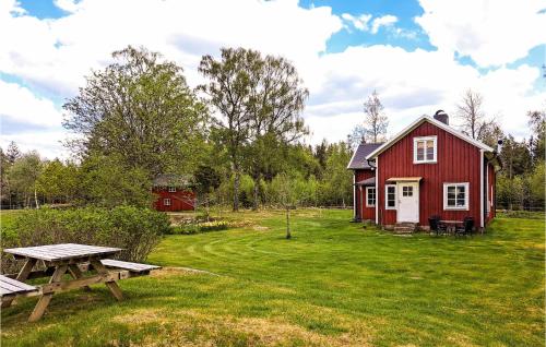a red barn with a picnic table in front of it at Gorgeous Home In Vårgårda With Wifi in Vårgårda