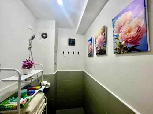 a bathroom with a shower with flowers on the wall at Affordable Condotel in Cebu in Cebu City