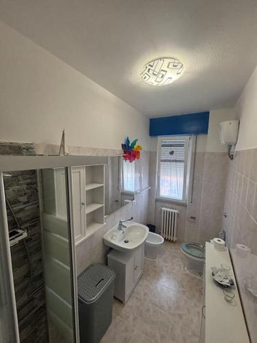 a bathroom with a sink and a toilet at Attico nel Mare in Rosignano Solvay