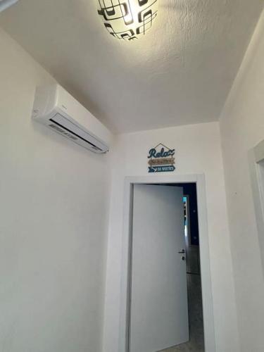 a room with a white ceiling and a white door at Attico nel Mare in Rosignano Solvay