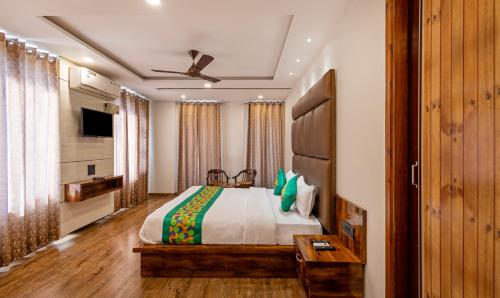 a bedroom with a bed and a ceiling fan at Treebo Anjukul in Dalhousie