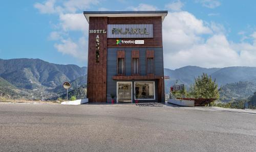 a building with a sign on the side of a road at Treebo Anjukul in Dalhousie