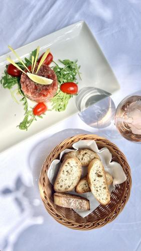 a basket of bread and vegetables on a plate at Sunraf Luxe Apartments in Budva