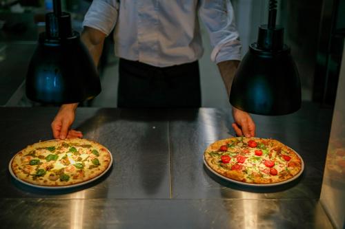 two pizzas sitting on top of a counter at Sunraf Luxe Apartments in Budva