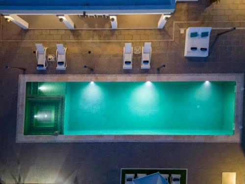 an overhead view of a public restroom with a green wall at Villa in San Antonio sleeps 10 in Ses Paisses