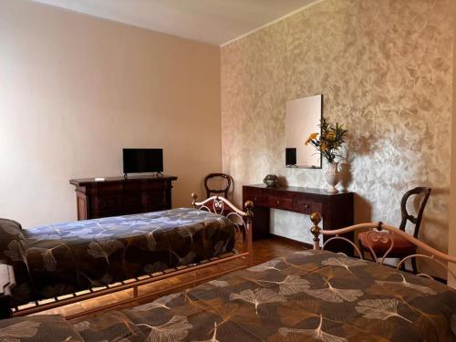 a bedroom with a bed and a desk and a bed sidx sidx sidx at La casa di Alberto lake view in Laveno