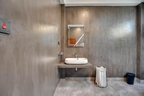 a bathroom with a sink and a mirror at Hasthri Boutique Blue Apartment in Ahangama with pool Near Beach in Ahangama